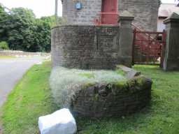 Oblique view of trough and Home Farm sign on wall, Beamish Home Farm July 2016